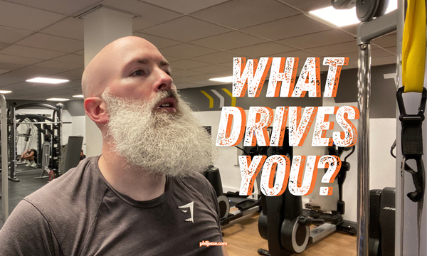 Performance coach Phil Jessé with determined expression and text overlay "What Drives YOU?"